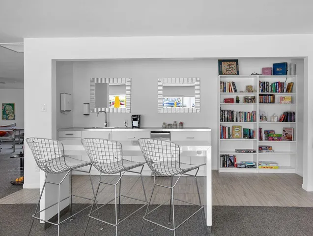 a spacious bedroom with a bed and a chandelier
