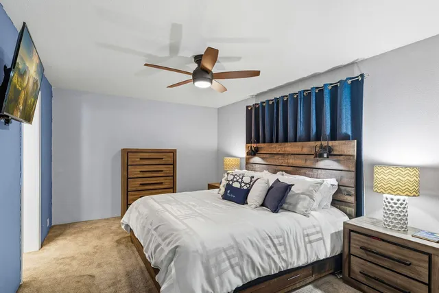 a bedroom with a bed and a television