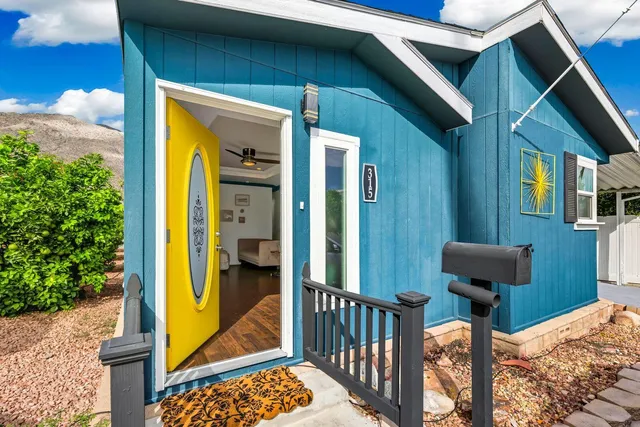 a view of a balcony with furniture and a potted plant