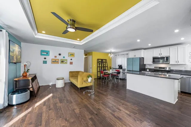 a living room with furniture and kitchen view