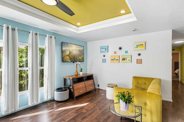 a living room with furniture and wooden floor