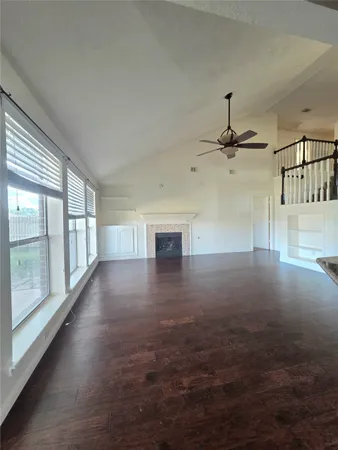 a view of a livingroom with a ceiling fan and window
