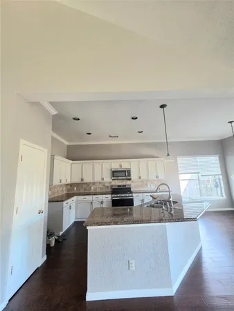 a view of a kitchen with a sink and cabinets