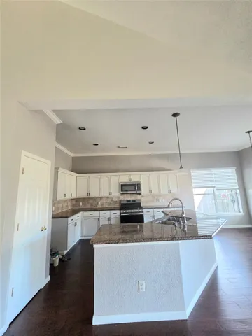 a view of a kitchen with a sink and cabinets