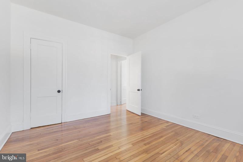 2707 Adams Mill Road Northwest, Unit 205 Washington, DC 20009 - Photo 18 of 28 a view of an empty room with wooden floor