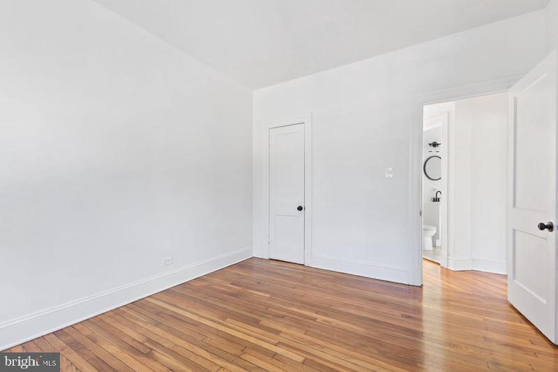 2707 Adams Mill Road Northwest, Unit 205 Washington, DC 20009 - Photo 19 of 28 a view of an empty room with wooden floor