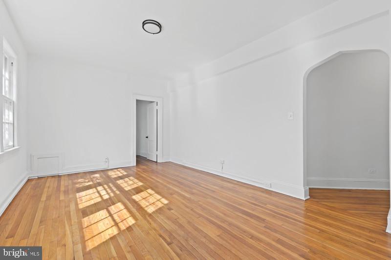 2707 Adams Mill Road Northwest, Unit 205 Washington, DC 20009 - Photo 7 of 28 a view of an empty room and wooden floor