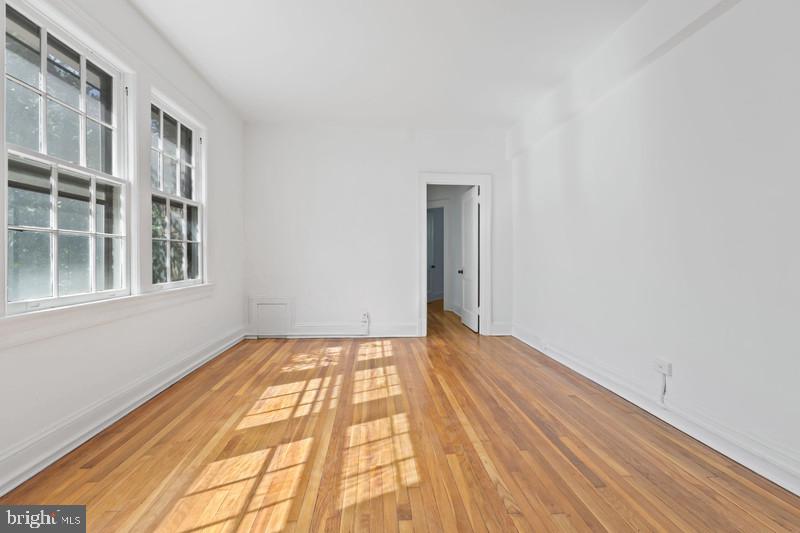 2707 Adams Mill Road Northwest, Unit 205 Washington, DC 20009 - Photo 8 of 28 a view of an empty room and window