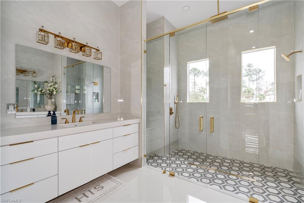 2313 6th Avenue Southeast Naples, FL 34117 - Photo 14 of 36 a spacious bathroom with a sink a mirror and a shower