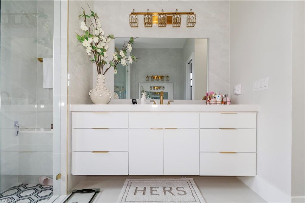 2313 6th Avenue Southeast Naples, FL 34117 - Photo 15 of 36 a bathroom with a sink and a mirror