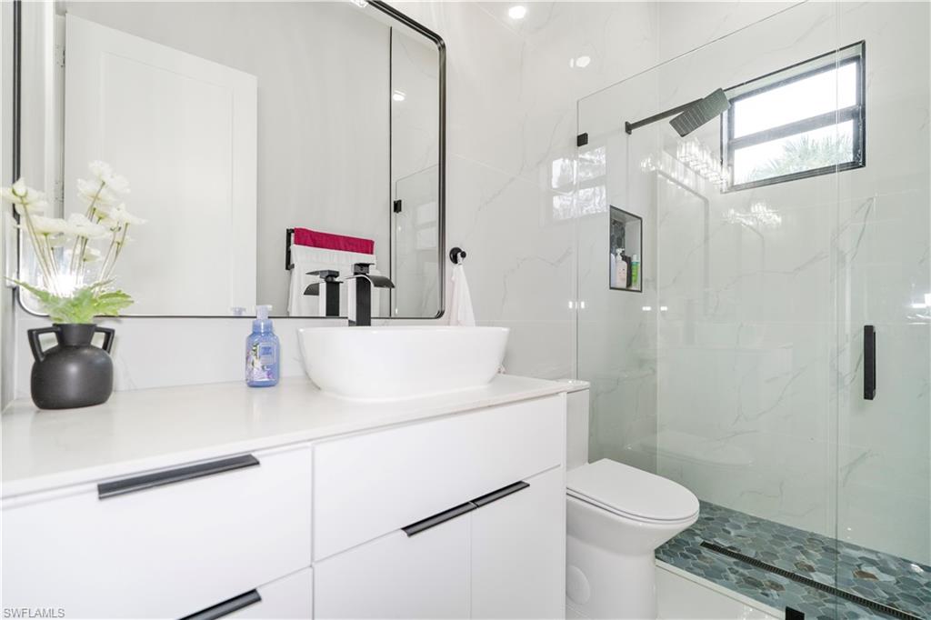 2313 6th Avenue Southeast Naples, FL 34117 - Photo 16 of 36 a bathroom with a sink toilet vanity and shower
