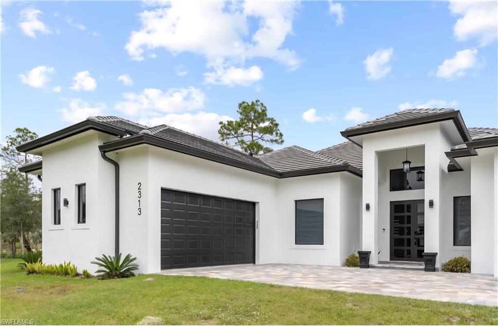 2313 6th Avenue Southeast Naples, FL 34117 - Photo 20 of 36 a house that has a lot of windows in it