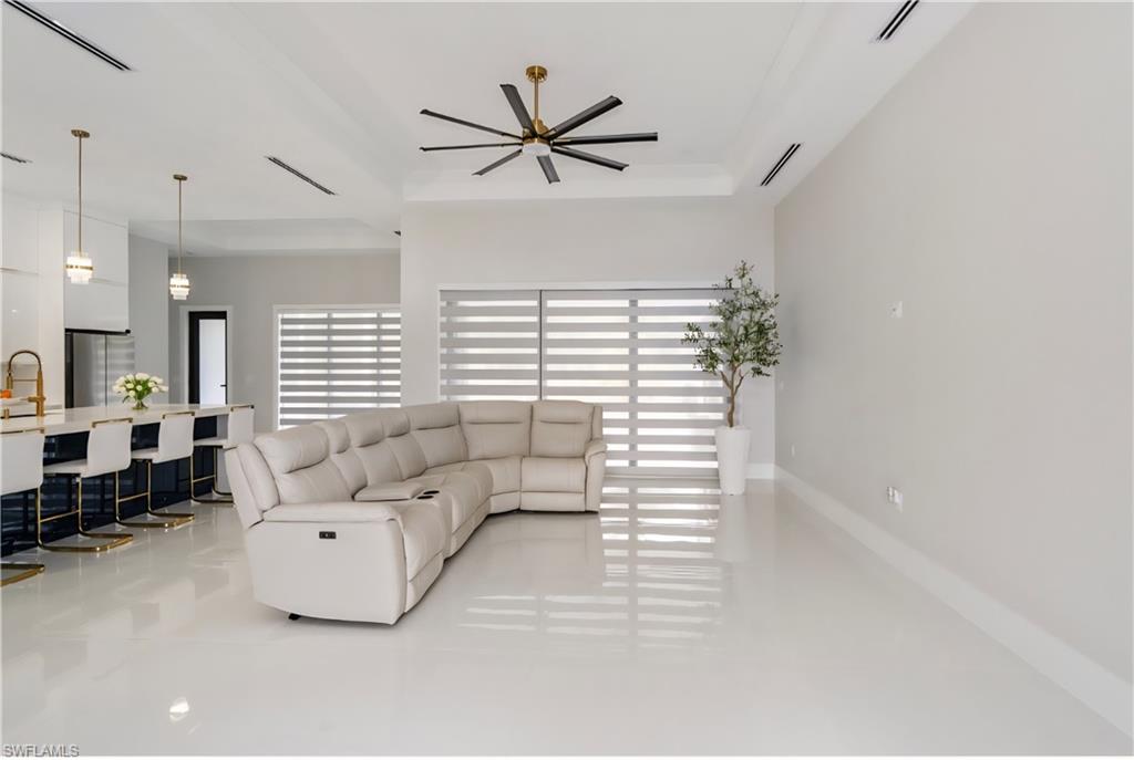 2313 6th Avenue Southeast Naples, FL 34117 - Photo 21 of 36 a living room with furniture and a ceiling fan