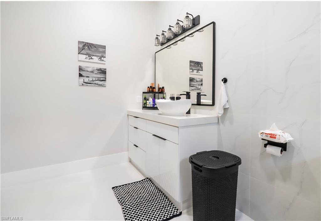 2313 6th Avenue Southeast Naples, FL 34117 - Photo 25 of 36 a bathroom with a sink toilet and mirror