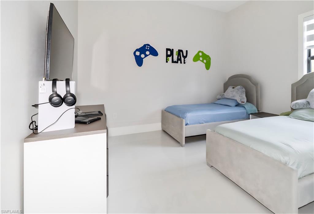 2313 6th Avenue Southeast Naples, FL 34117 - Photo 27 of 36 a bedroom with two beds and a couch