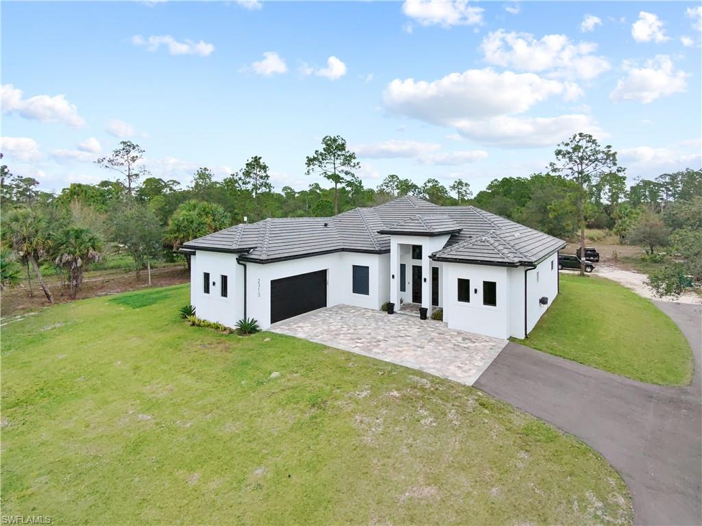 2313 6th Avenue Southeast Naples, FL 34117 - Photo 3 of 36 a house view with a garden space