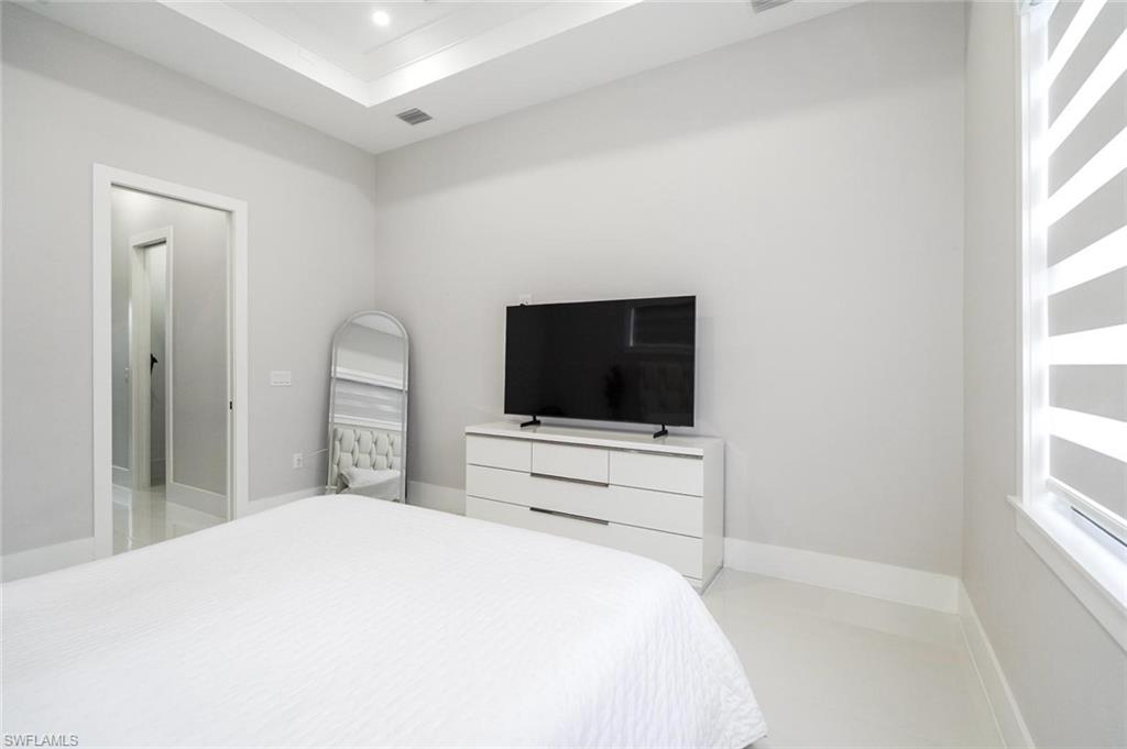 2313 6th Avenue Southeast Naples, FL 34117 - Photo 33 of 36 a bedroom with a bed and a flat screen tv