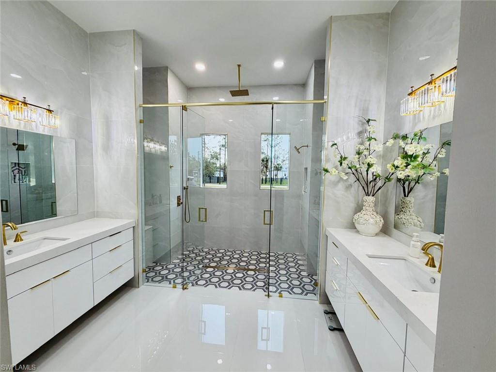 2313 6th Avenue Southeast Naples, FL 34117 - Photo 36 of 36 a bathroom with a granite countertop sink a toilet and shower