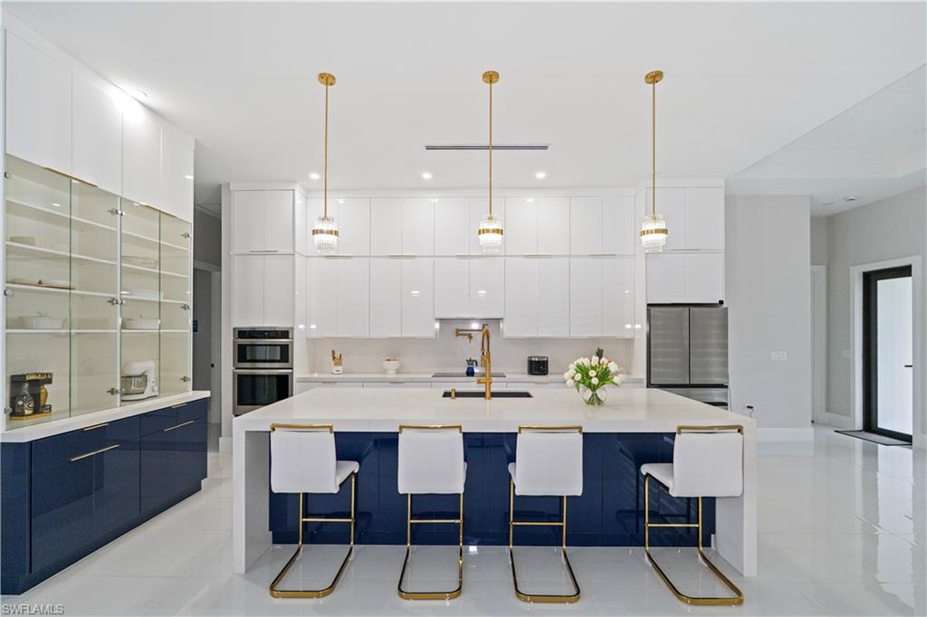 2313 6th Avenue Southeast Naples, FL 34117 - Photo 7 of 36 a view of a dining room and livingroom with furniture wooden floor a chandelier
