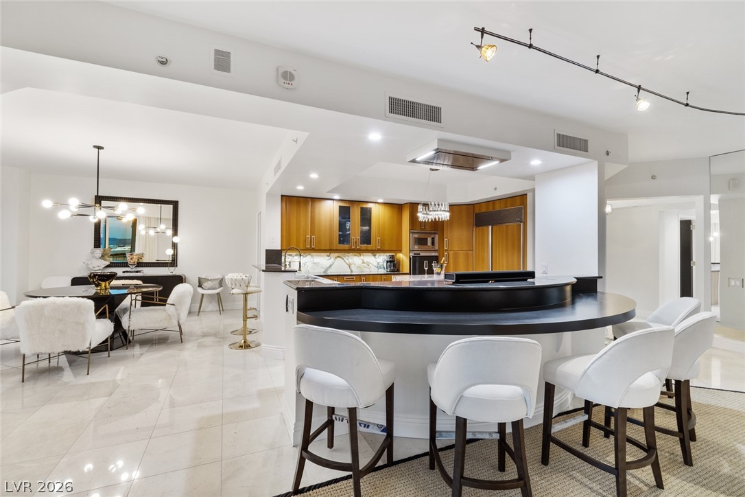 2857 Paradise Road, Unit 602 Las Vegas, NV 89109 - Photo 6 of 33 Polished tile flooring flows seamlessly from the contemporary dining area into the modern kitchen.