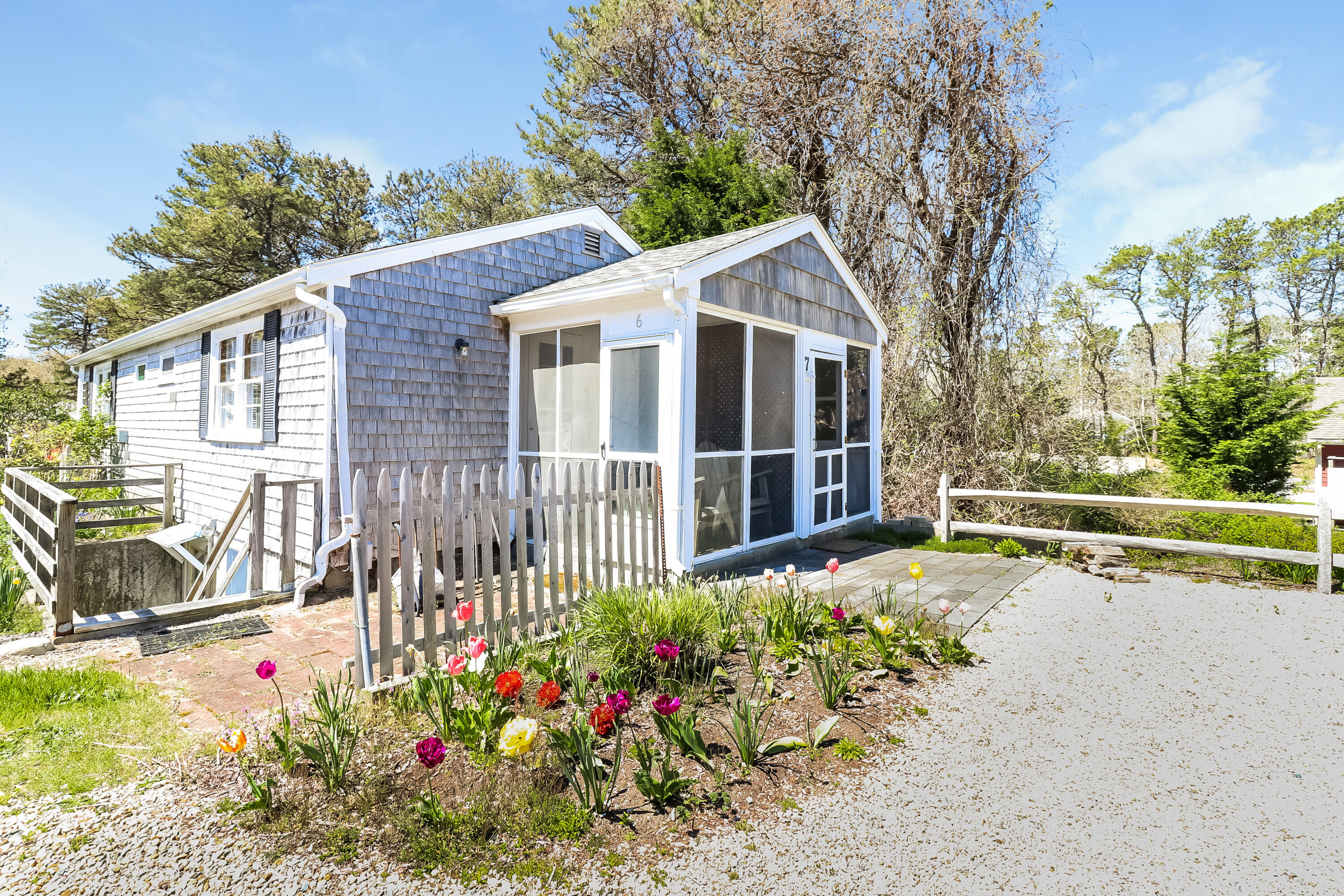 82 Shore Road, Unit 7 Truro, MA 02666 - Photo 11 of 13 a view of a house with a yard and garden