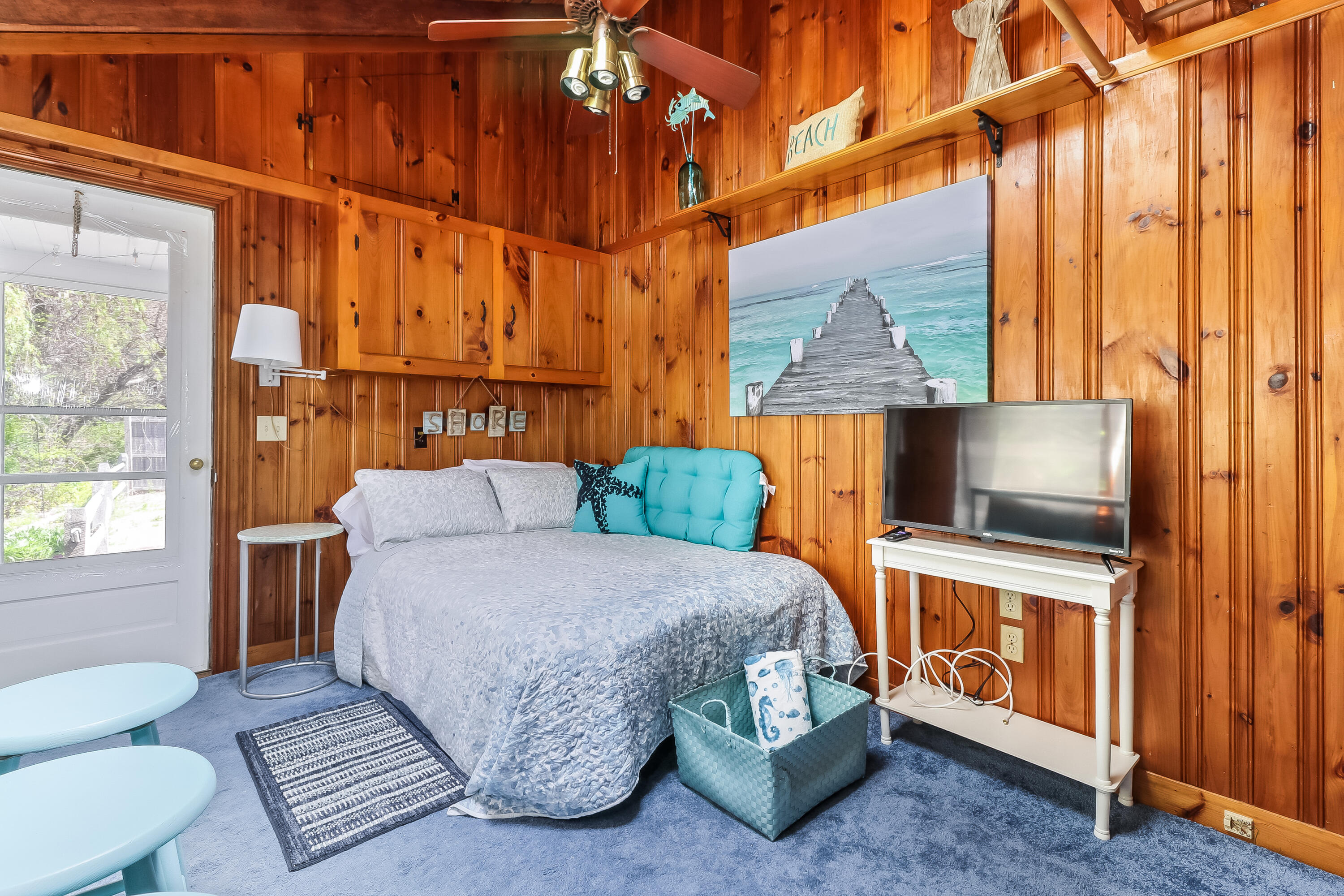 82 Shore Road, Unit 7 Truro, MA 02666 - Photo 4 of 13 a bedroom with a bed and a flat screen tv