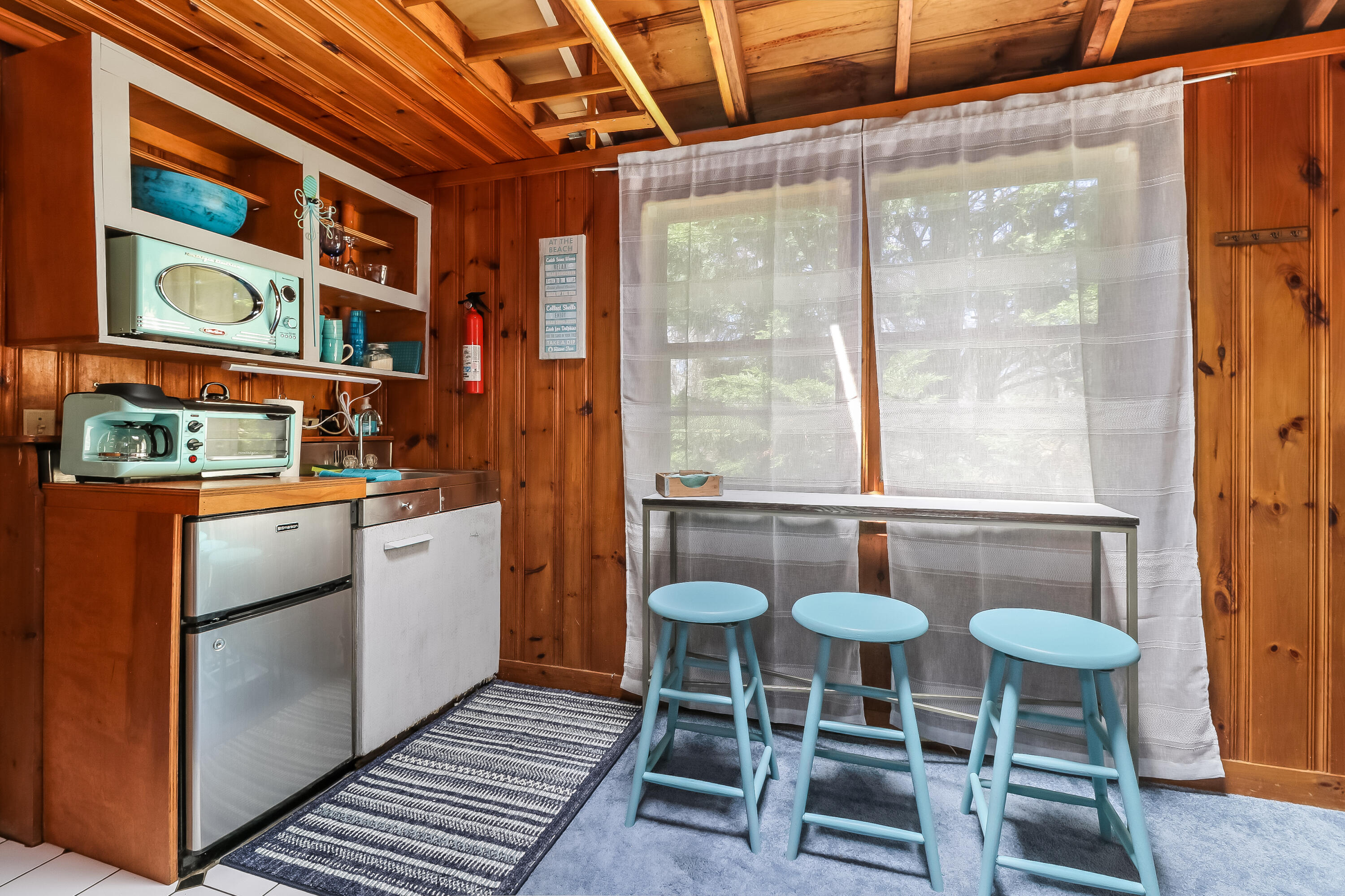 82 Shore Road, Unit 7 Truro, MA 02666 - Photo 5 of 13 a kitchen with stainless steel appliances granite countertop a table and chairs