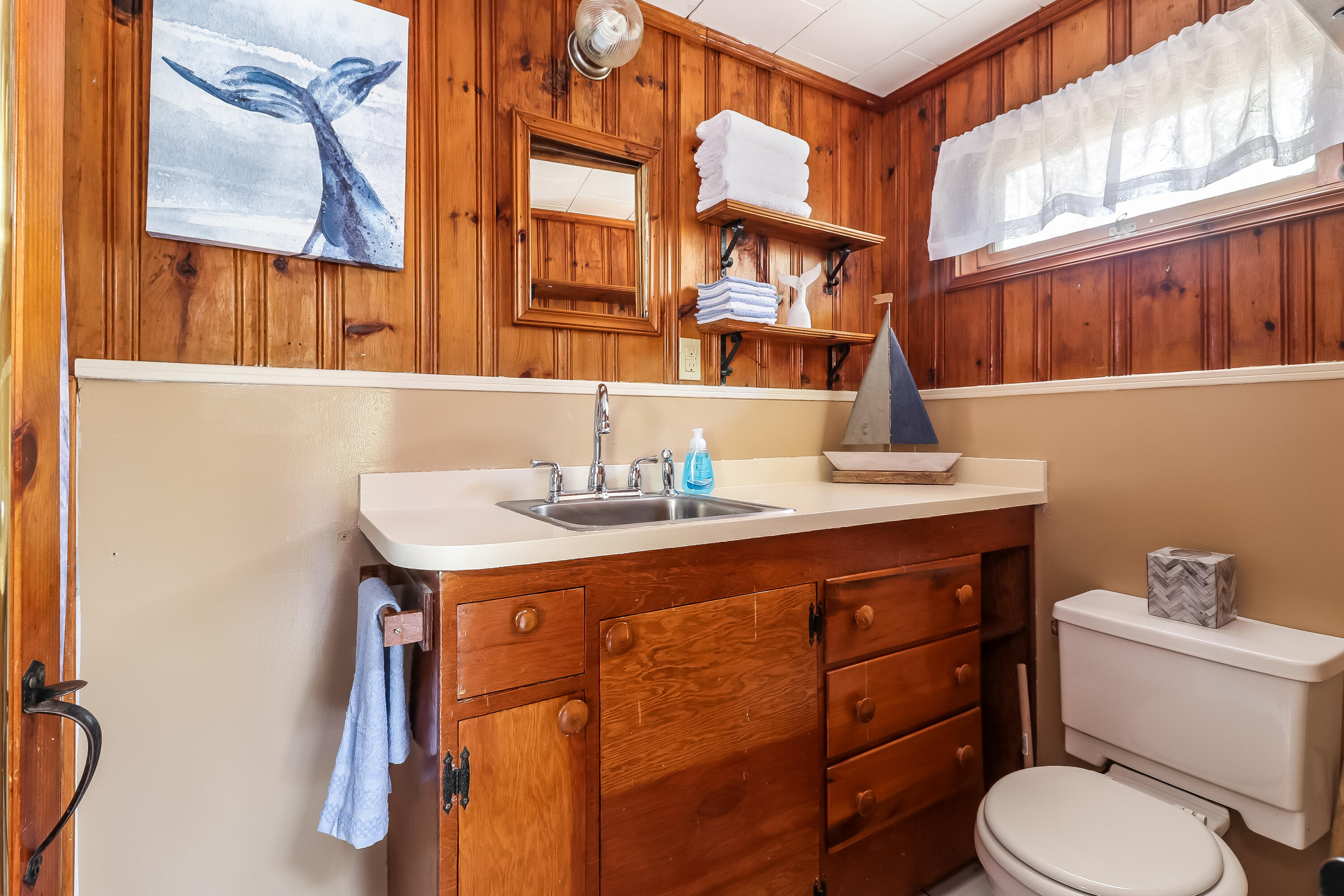 82 Shore Road, Unit 7 Truro, MA 02666 - Photo 7 of 13 a bathroom with a sink a toilet and a window