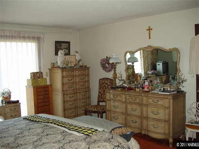 570 Cyma Circle Reno, NV 89503 - Photo 9 of 13 a bedroom with a bed and a dresser