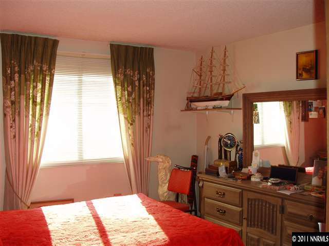 570 Cyma Circle Reno, NV 89503 - Photo 10 of 13 a bedroom with a bed and a window