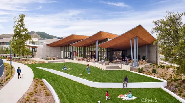 a view of a house with swimming pool and sitting area