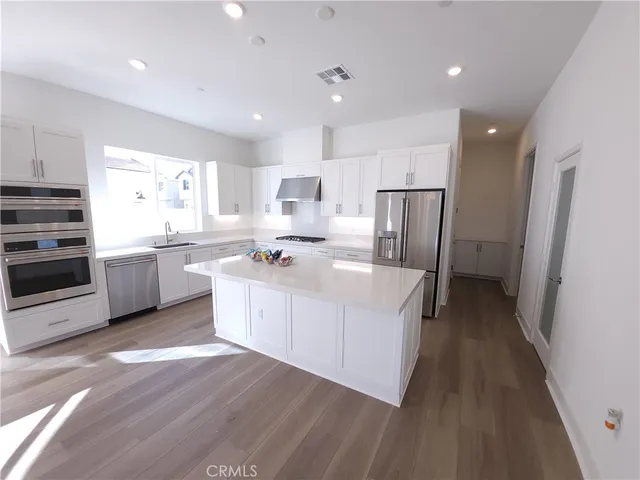 a view of kitchen with furniture and wooden floor