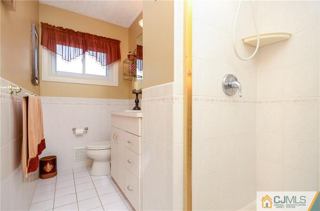 19 Rutgers Road Old Bridge, NJ 08859 - Photo 15 of 25 a bathroom with a toilet sink and a shower
