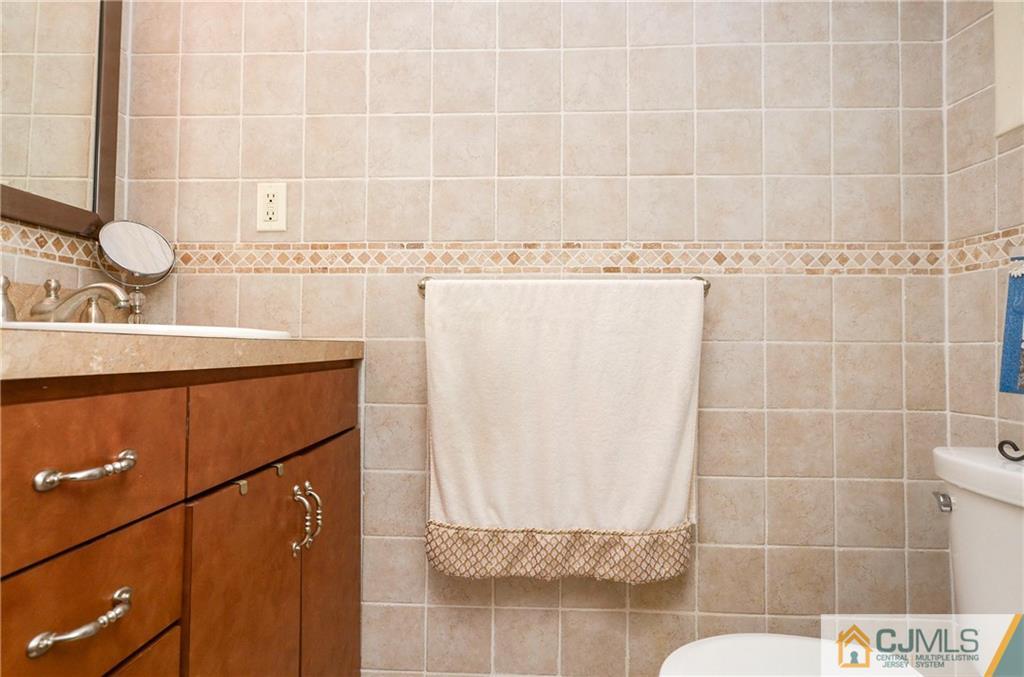 19 Rutgers Road Old Bridge, NJ 08859 - Photo 17 of 25 a bathroom with a sink a mirror and a shower