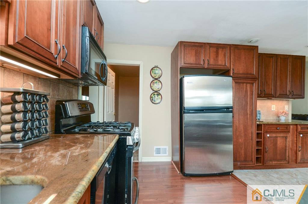 19 Rutgers Road Old Bridge, NJ 08859 - Photo 3 of 25 a kitchen with stainless steel appliances granite countertop a refrigerator and a sink