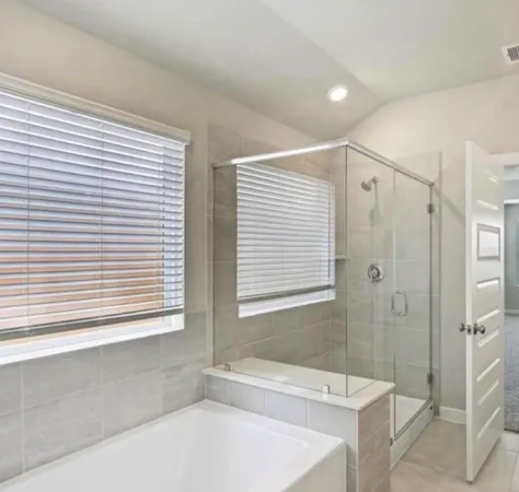 a bathroom with a bathtub and a shower