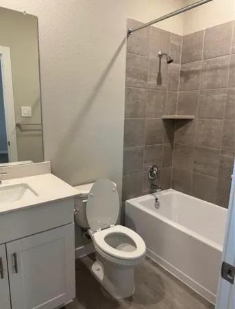 a bathroom with a sink a toilet and bathtub