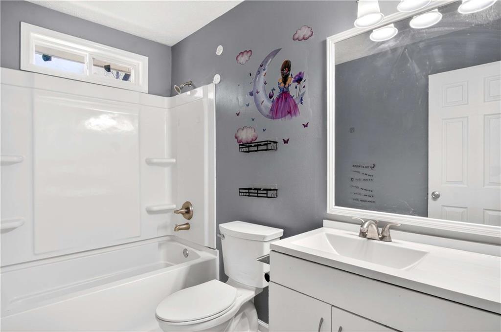 808 Emerald Chase Powder Springs, GA 30127 - Photo 18 of 32 a bathroom with a sink a toilet and a bathtub