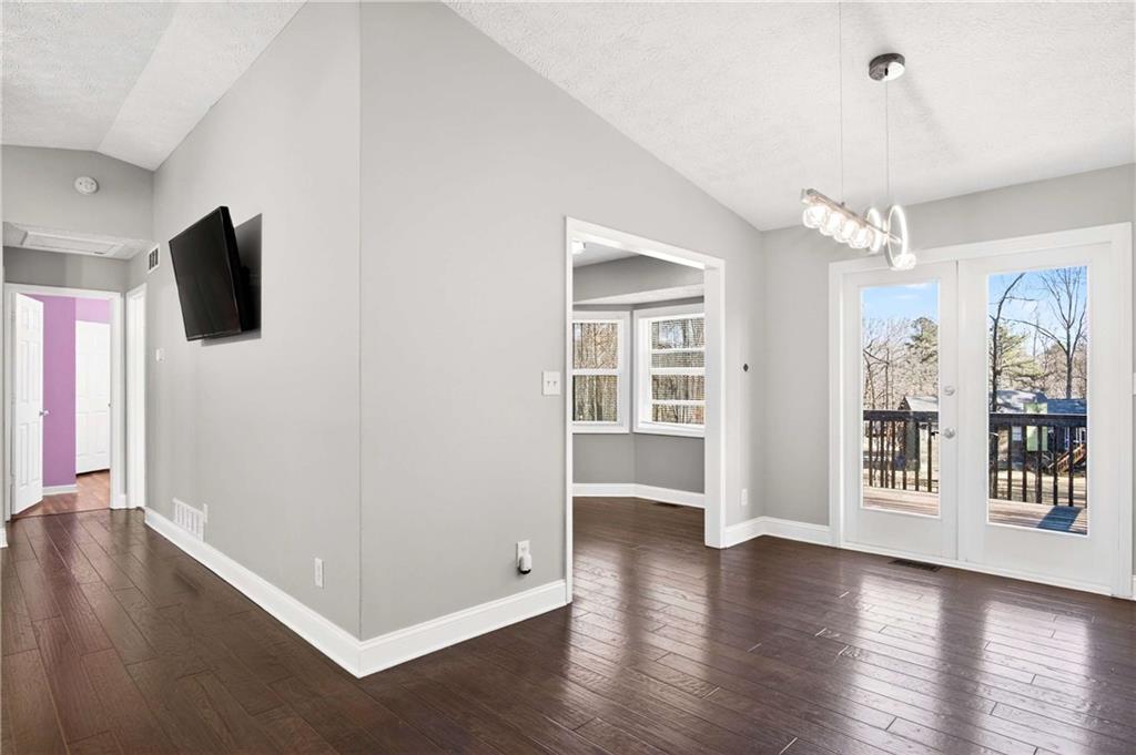 808 Emerald Chase Powder Springs, GA 30127 - Photo 6 of 32 an empty room with wooden floor and windows