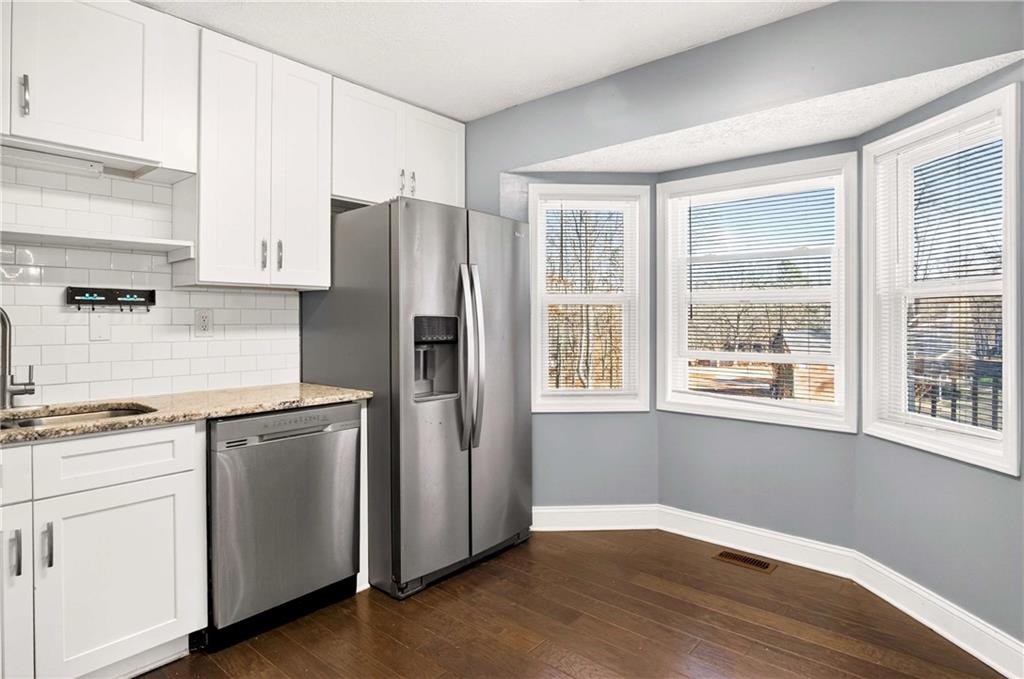 808 Emerald Chase Powder Springs, GA 30127 - Photo 9 of 32 a kitchen with stainless steel appliances a refrigerator sink and cabinets