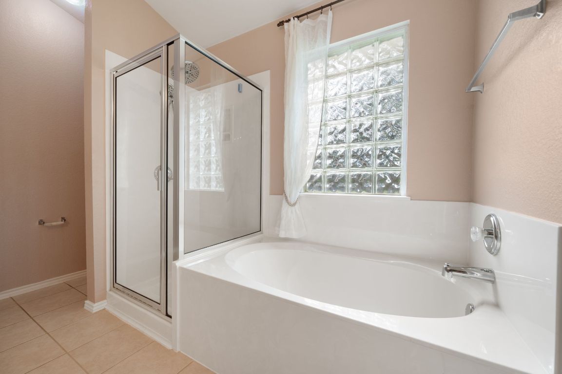 2361 Pearson Way Round Rock, TX 78665 - Photo 11 of 32 a bathroom with a bathtub and a shower