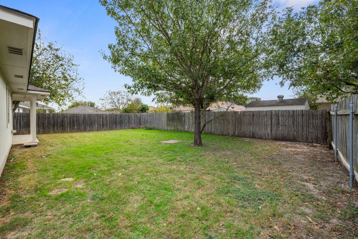 2361 Pearson Way Round Rock, TX 78665 - Photo 21 of 32 a view of a backyard with large trees and wooden fence