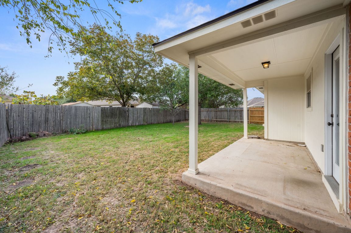 2361 Pearson Way Round Rock, TX 78665 - Photo 23 of 32 a view of a backyard with large trees and wooden fence