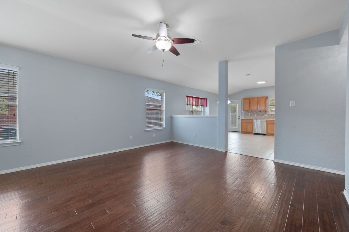 2361 Pearson Way Round Rock, TX 78665 - Photo 3 of 32 a view of an empty room with a window and wooden floor