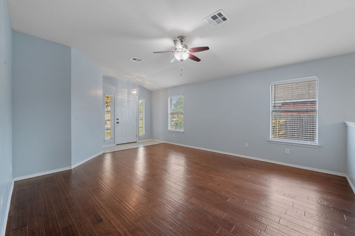 2361 Pearson Way Round Rock, TX 78665 - Photo 4 of 32 a view of an empty room with wooden floor and a window