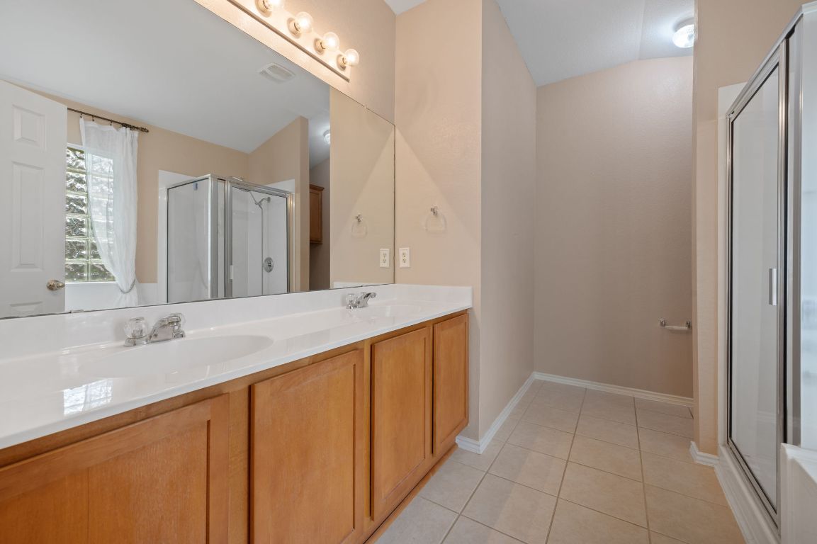 2361 Pearson Way Round Rock, TX 78665 - Photo 10 of 32 a bathroom with a granite countertop sink and a mirror