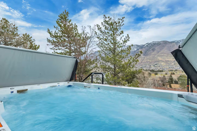 11789 Nicklaus Road Sandy, UT 84092 - Photo 56 of 58 View of swimming pool featuring a mountain view and a hot tub