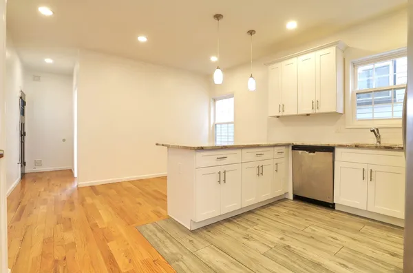 a kitchen with white cabinets and white appliances
