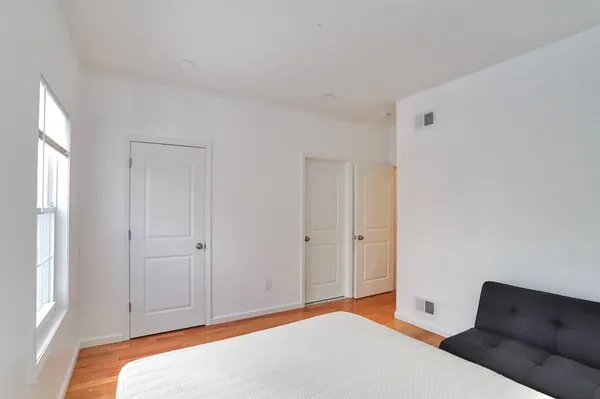 a bedroom with a bed and a window