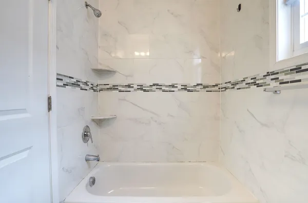 a bathroom with a shower and a tub